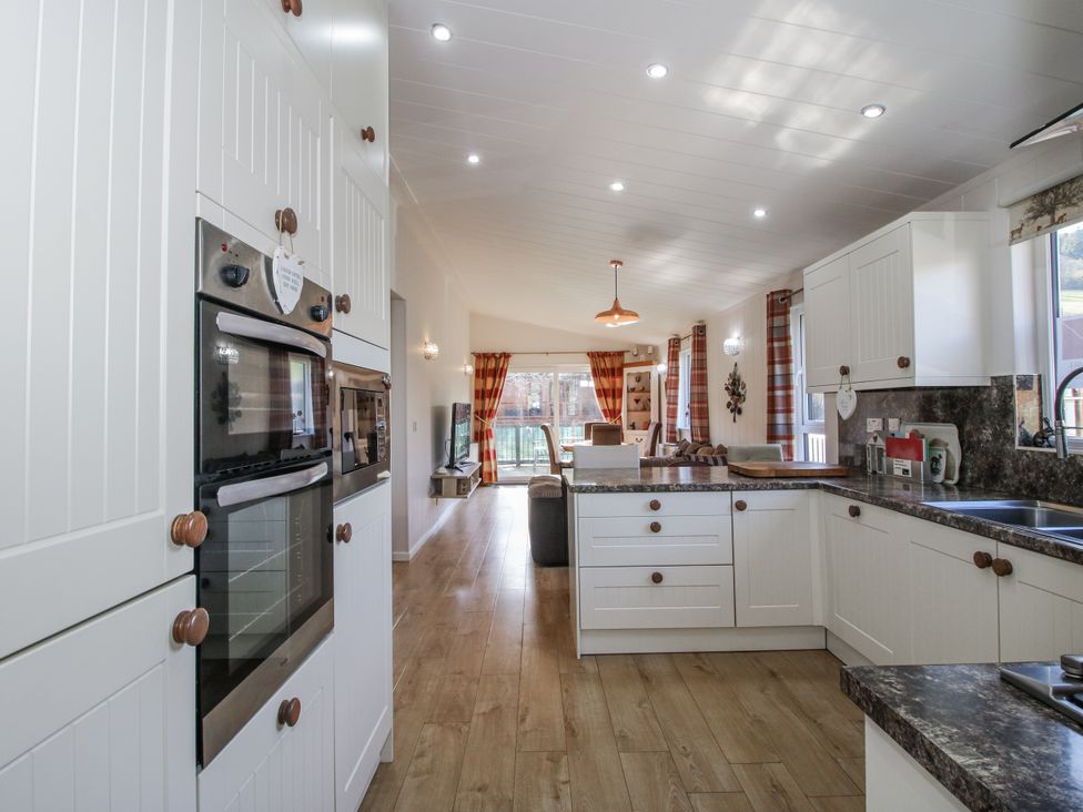 A kitchen with appliances and countertops at Hazel Lodge Clunton near Clun