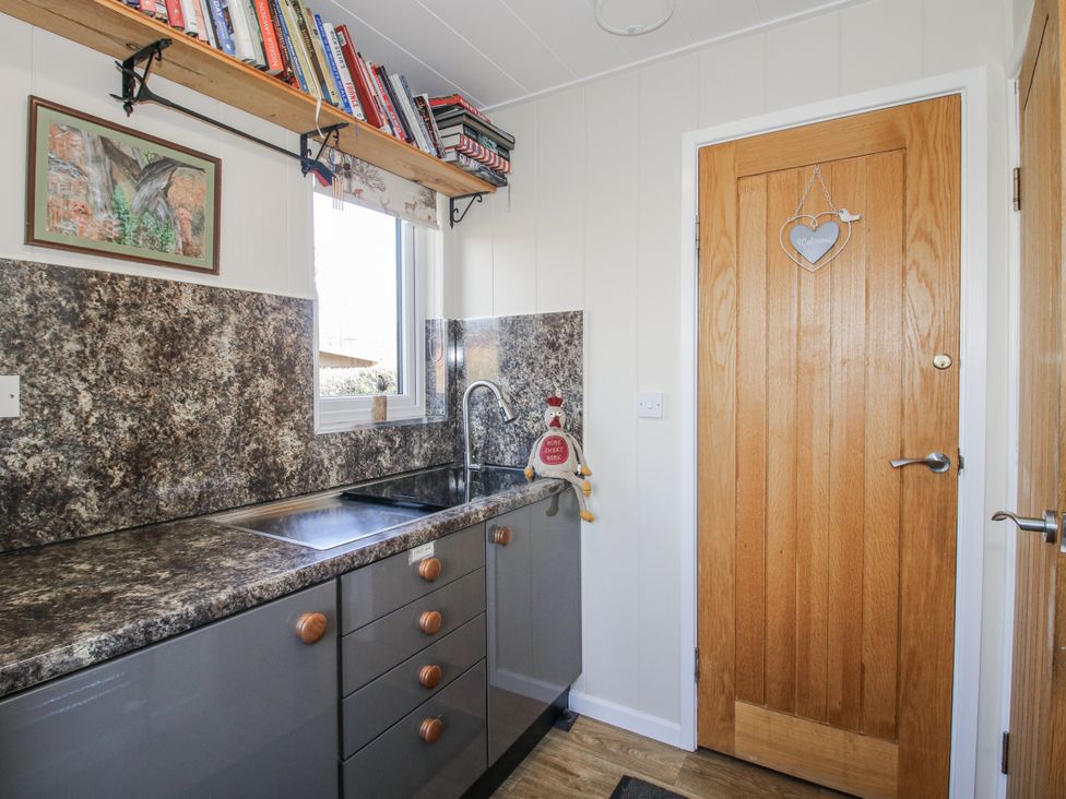 A kitchen with a sink and cabinets at Hazel Lodge in Clunton near Clun