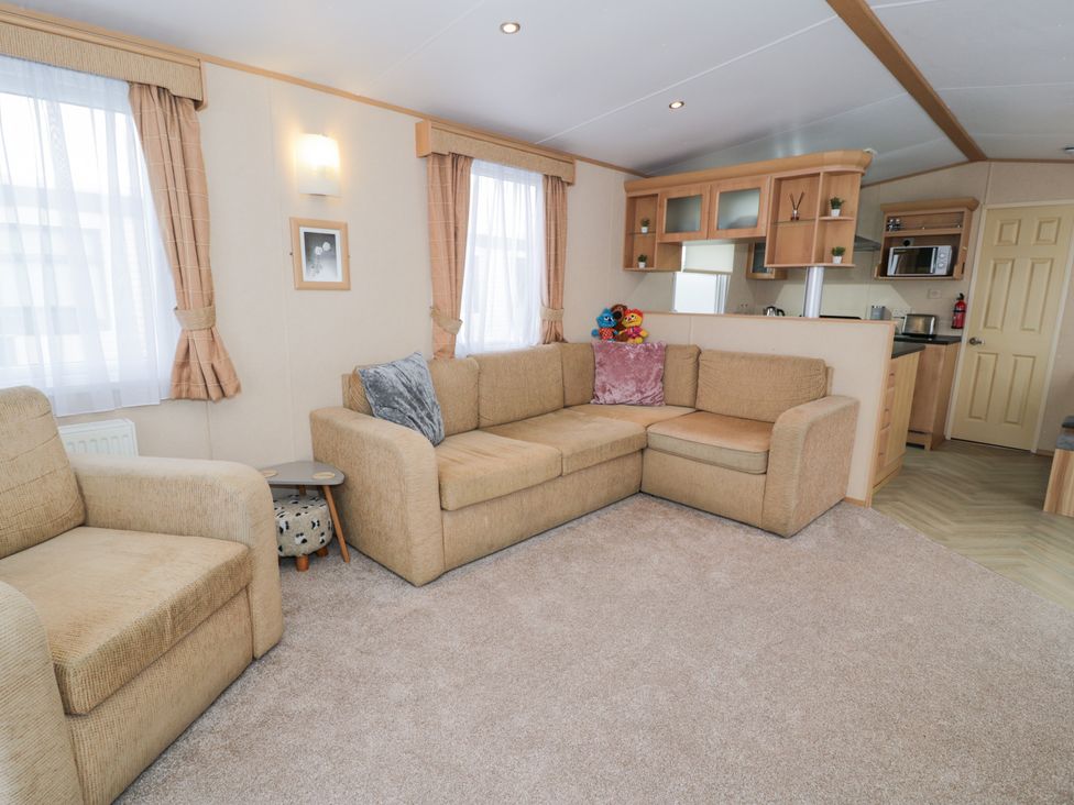 A living room with a sofa and a coffee table at 11, Beachfields