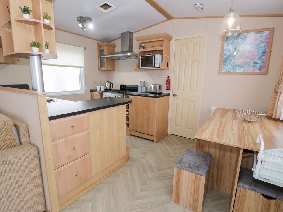 A kitchen with cabinets and appliances at 11, Beachfields