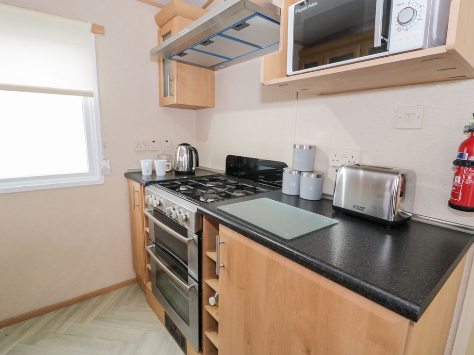 A kitchen with appliances and utensils at 11, Beachfields