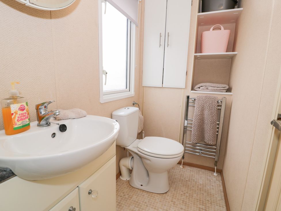 A bathroom with a sink and toilet at 11, Beachfields