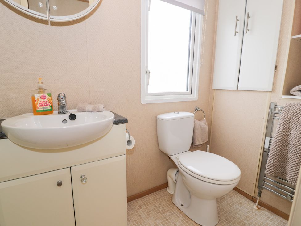A bathroom with a sink and toilet at 11, Beachfields