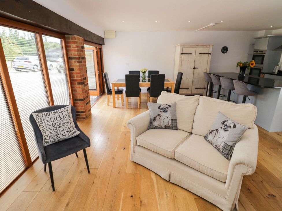 A living room with a sofa and dining area at Underhill House Annex