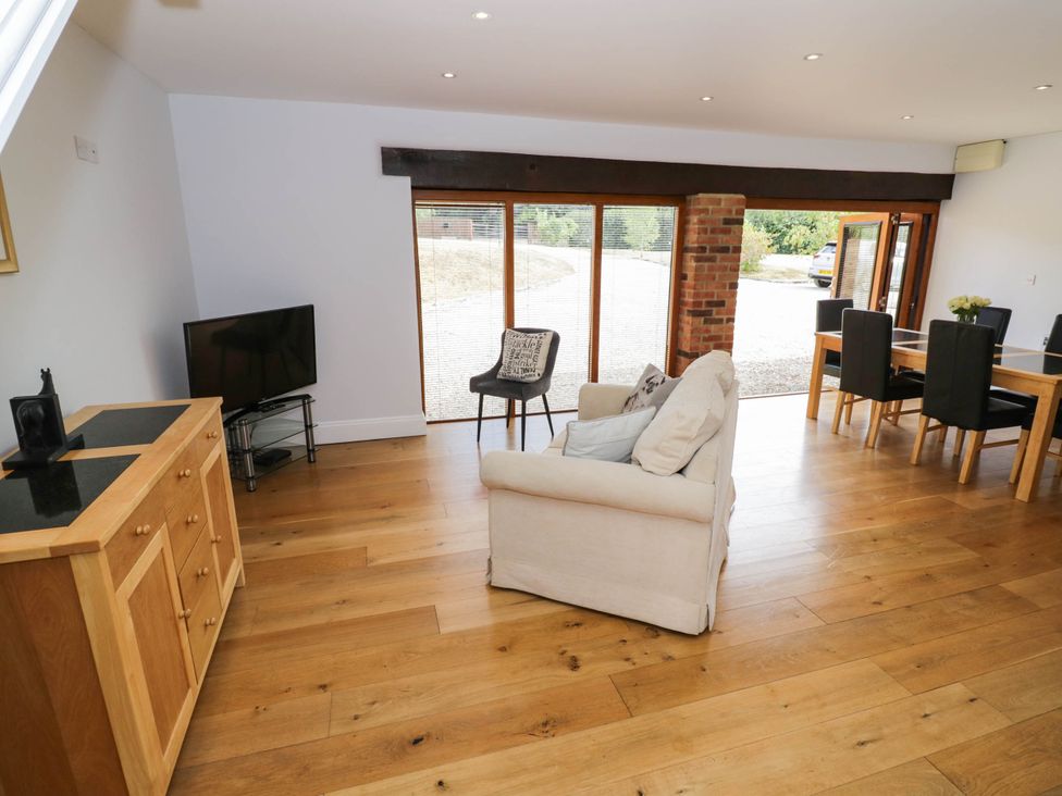 A living room with a sofa and television at Underhill House Annex