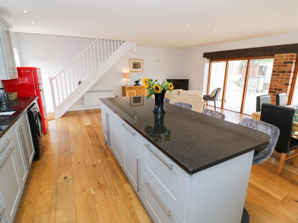 A kitchen with a red fridge and a kitchen island at Underhill House Annex