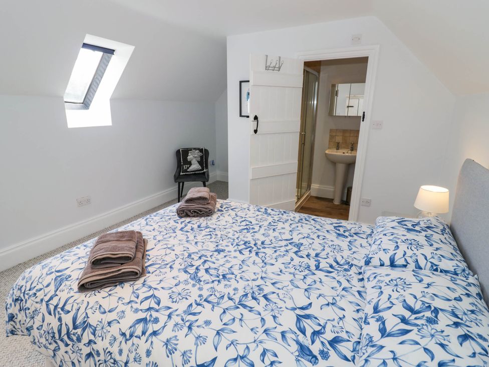 A bedroom with a bed and ensuite bathroom at Underhill House Annex