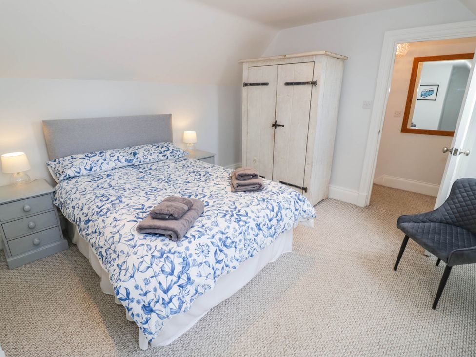 A bedroom with a bed and wardrobe at Underhill House Annex 