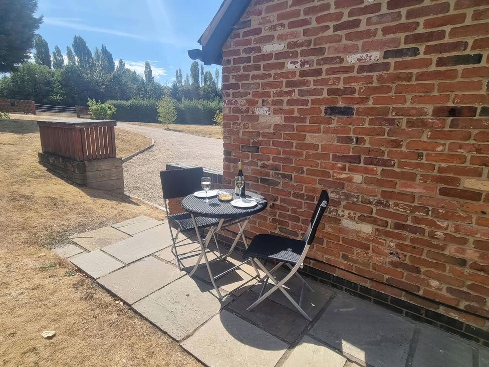 A table set with chairs outside at Underhill House Annex Stratford-Upon-Avon