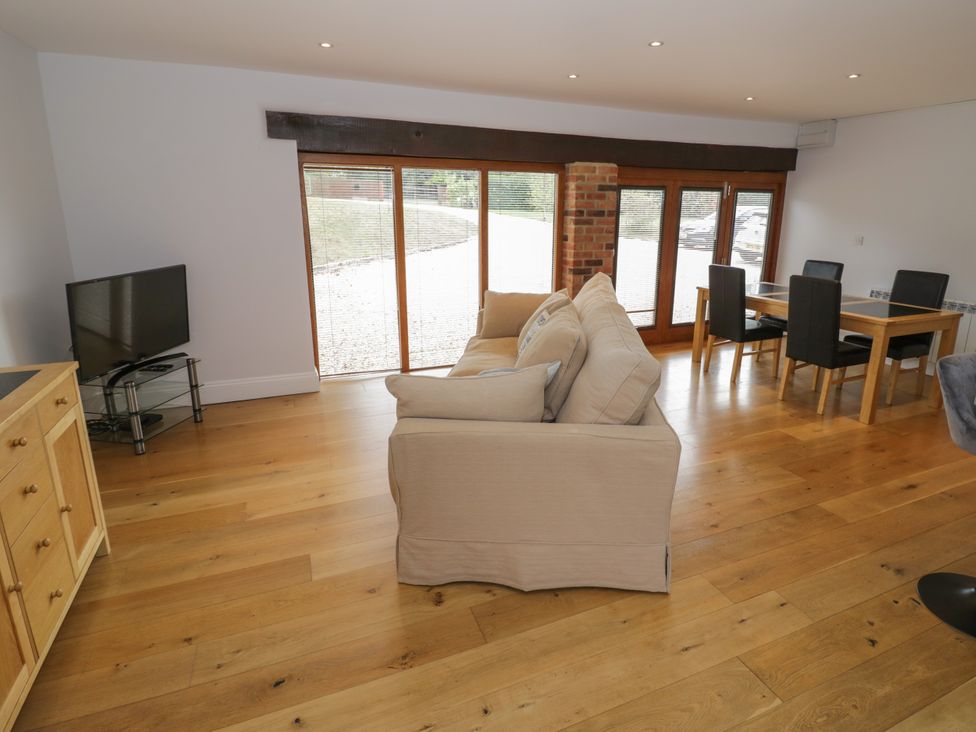 A living room with a sofa and dining area at Underhill House Annex Stratford-Upon-Avon