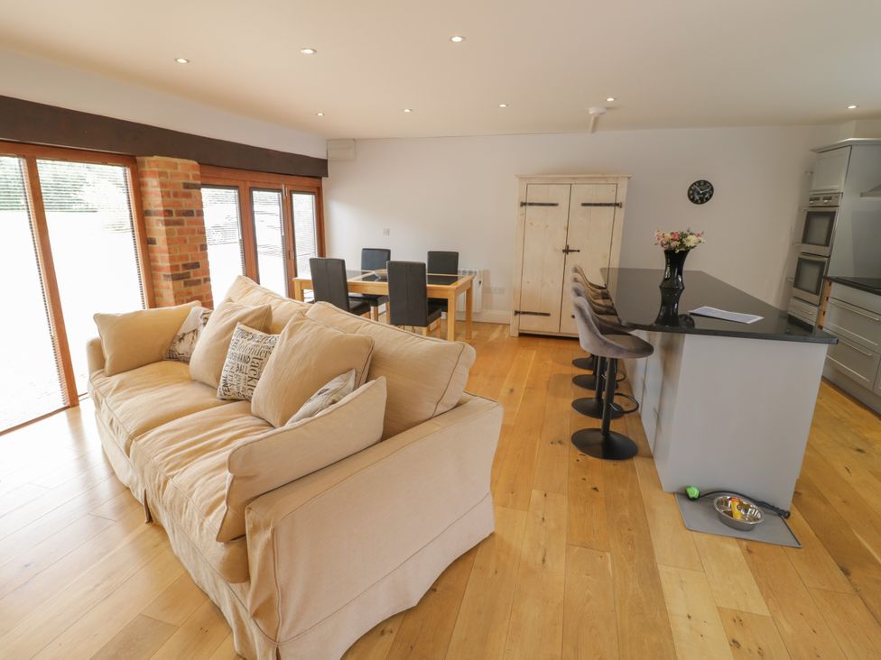 A kitchen with sofa and dining area at Underhill House Annex Stratford-Upon-Avon