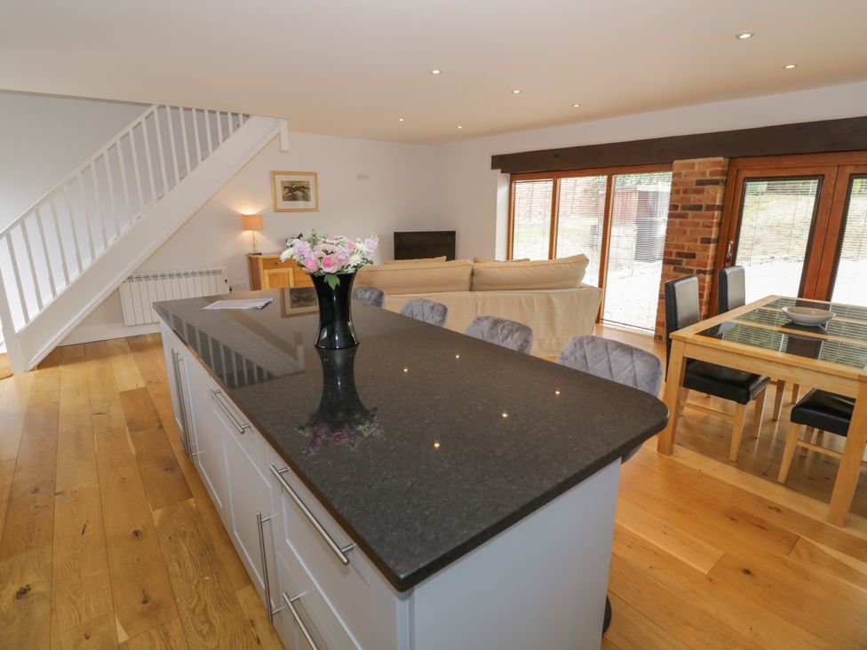 A kitchen with a dining area and sofa at Underhill House Annex Stratford-Upon-Avon