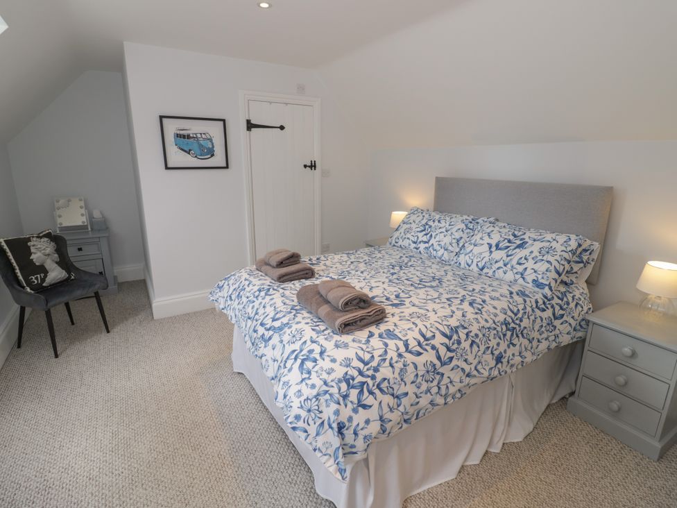 A bedroom with a bed and nightstands at Underhill House Annex Stratford-Upon-Avon