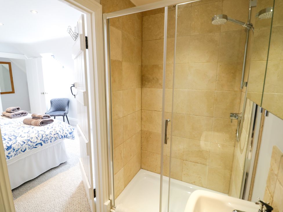 A bathroom with a shower and view of a bedroom at Underhill House Annex Stratford-Upon-Avon