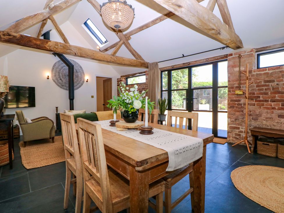 A dining room with a table and chairs at The Barn in 