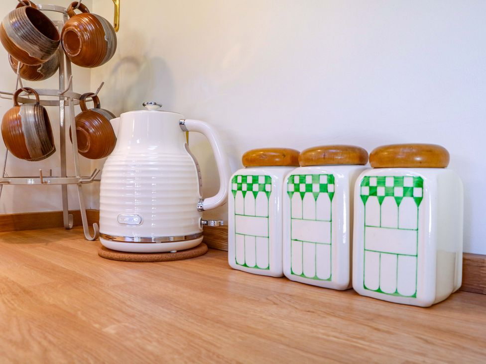 A kettle and storage jars on a kitchen countertop at The Barn 