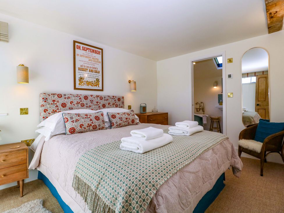 A bedroom with a bed and nightstand at The Barn 