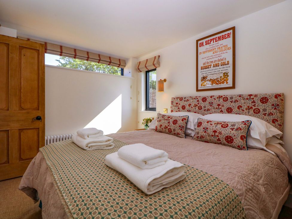 A bedroom with a bed and decorative pillows at The Barn in 