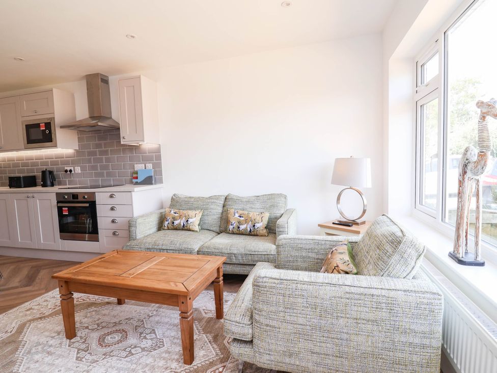 A living room with a sofa and coffee table at 6 Bastion Close in Prestatyn