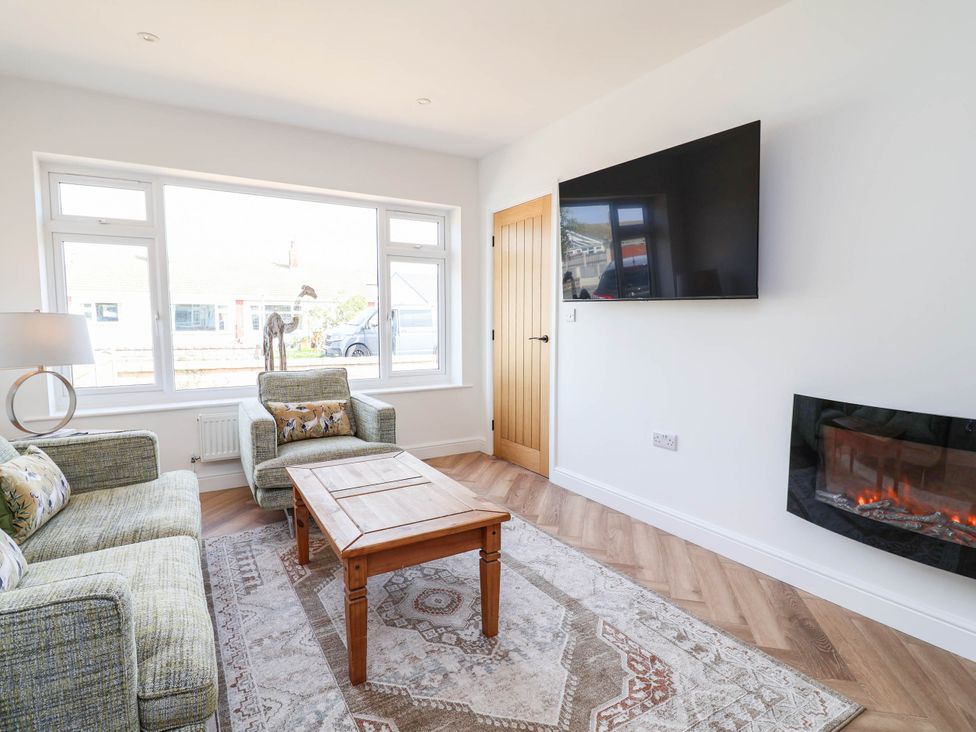 A living room with a sofa and coffee table at 6 Bastion Close in Prestatyn