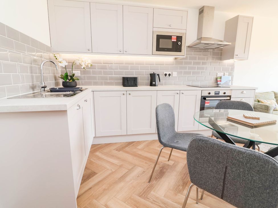 A kitchen with cabinets and appliances at 6 Bastion Close in Prestatyn