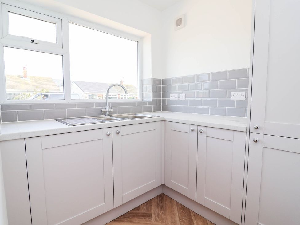 A kitchen with a sink and cabinets at 6 Bastion Close in Prestatyn