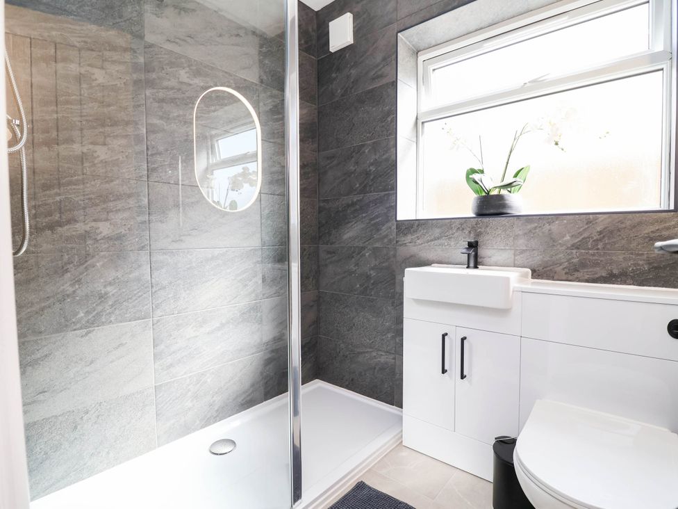 A bathroom with a shower and sink at 6 Bastion Close Prestatyn