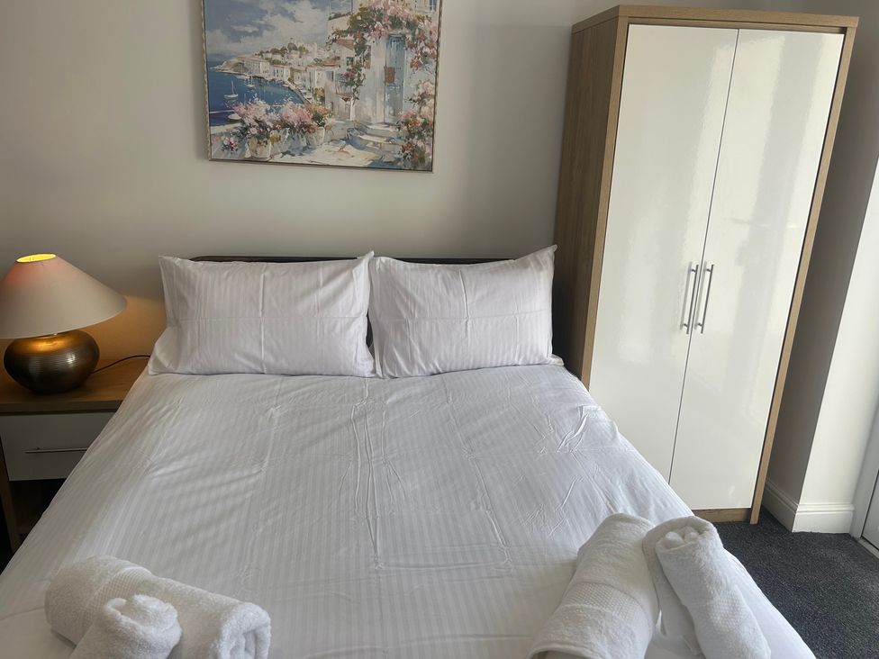 A bedroom with a bed and wardrobe at 6 Bastion Close Prestatyn