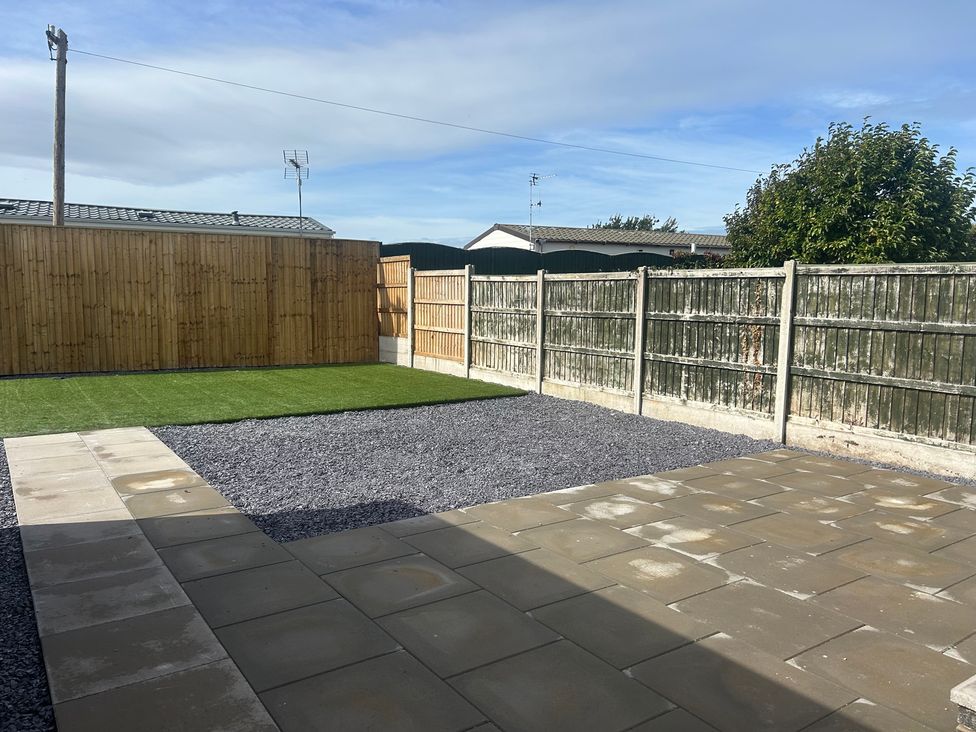 A garden with gravel and grass areas at 6 Bastion Close Prestatyn