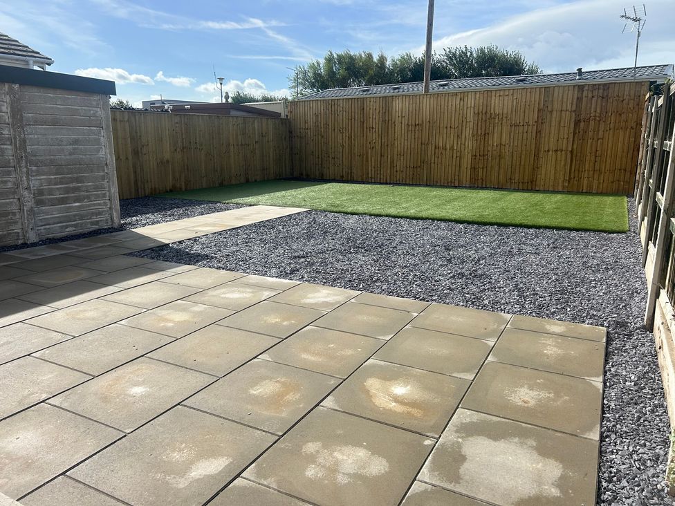 A garden with gravel area and artificial grass at 6 Bastion Close Prestatyn