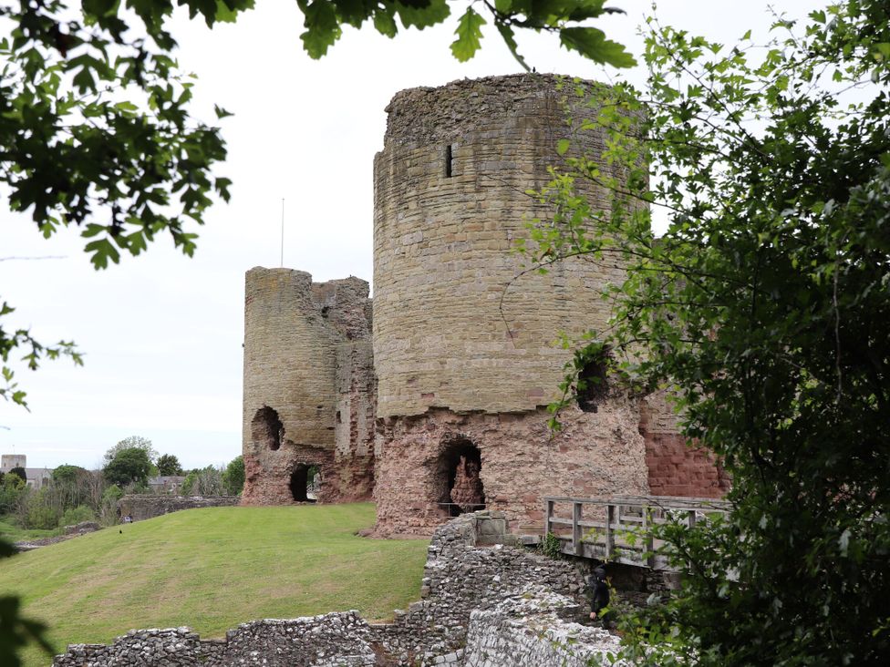 A view of a castle with towers and greenery at 21 Bastion Gardens in Prestatyn