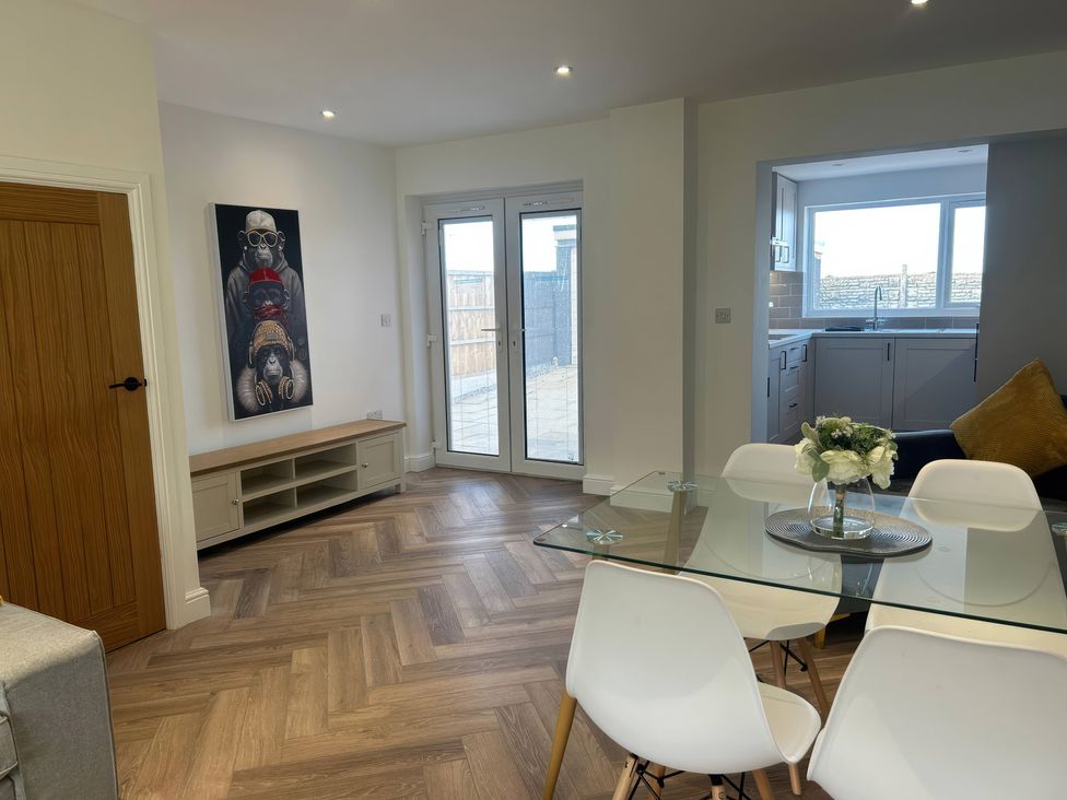 A dining room with a table and chairs at 21 Bastion Gardens in Prestatyn