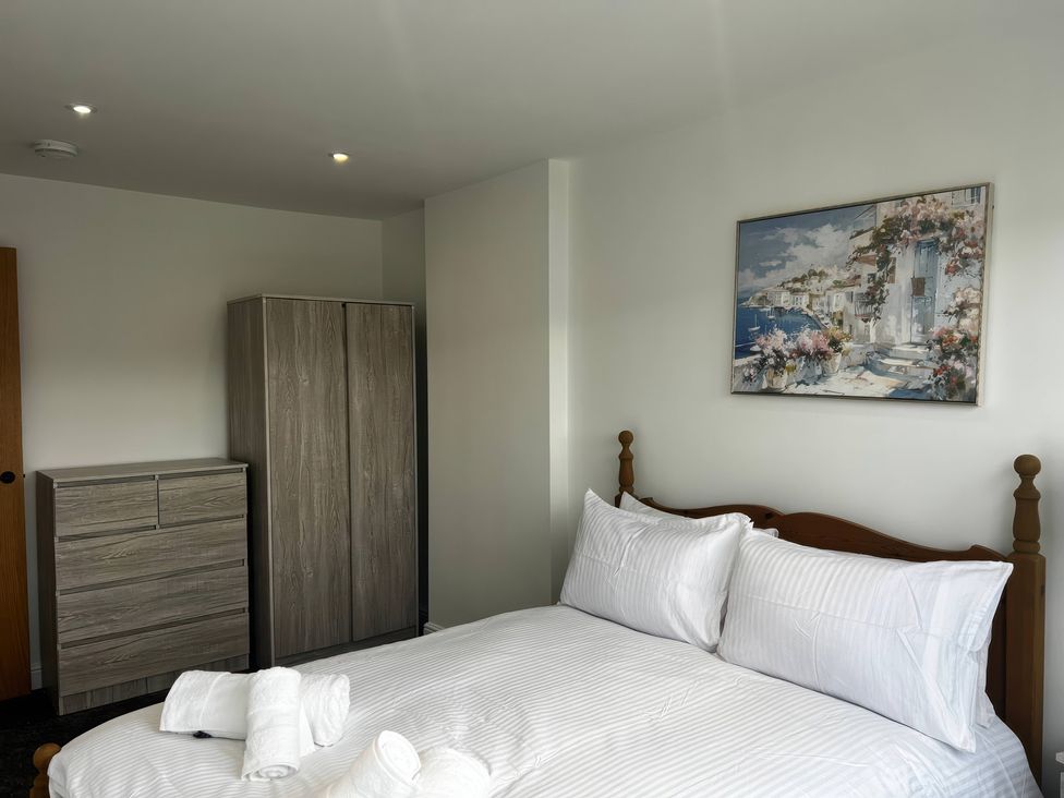 A bedroom with a bed and wardrobe at 21 Bastion Gardens Prestatyn