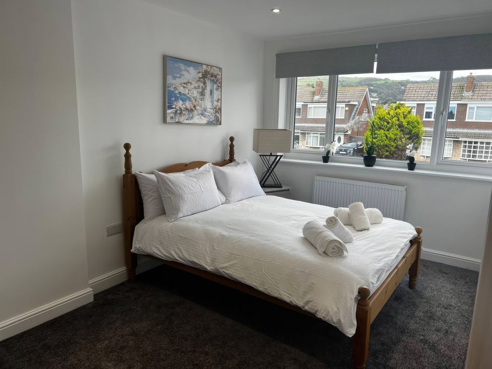 A bedroom with a bed and side table at 21 Bastion Gardens Prestatyn