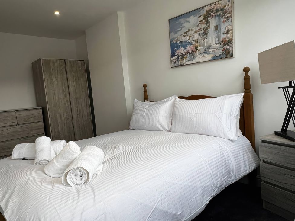 A bedroom with a bed and wardrobe at 21 Bastion Gardens Prestatyn