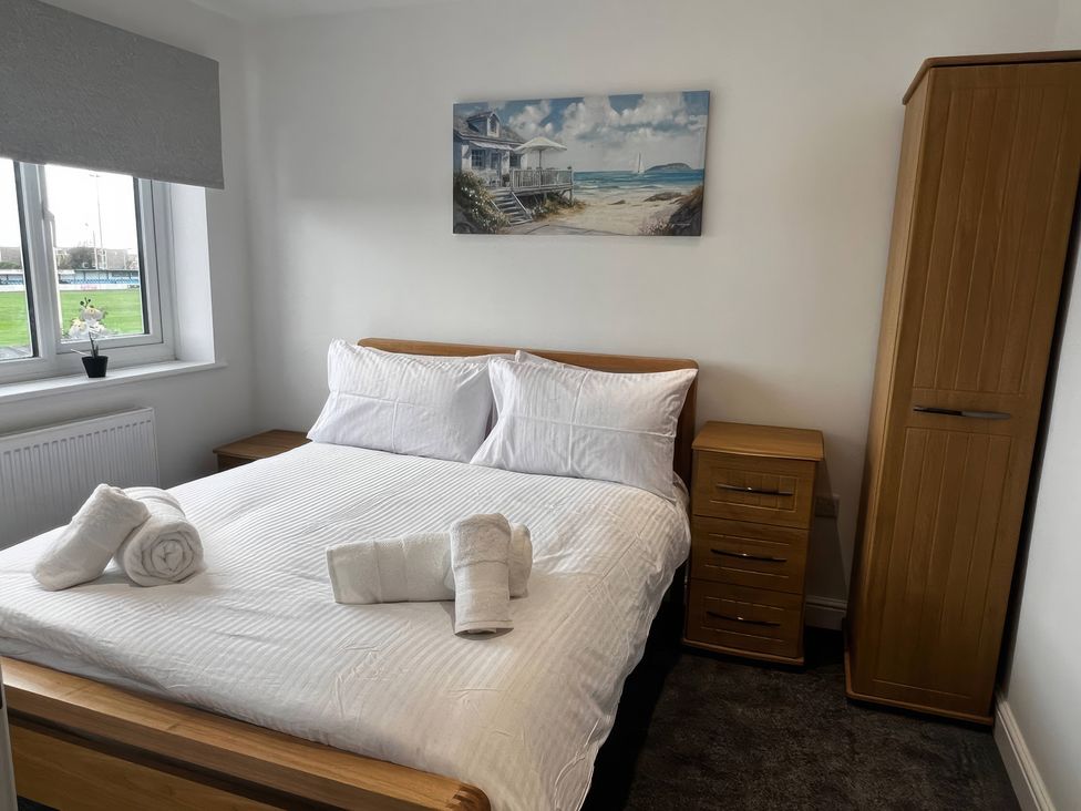 A bedroom with a bed and bedside table at 21 Bastion Gardens Prestatyn