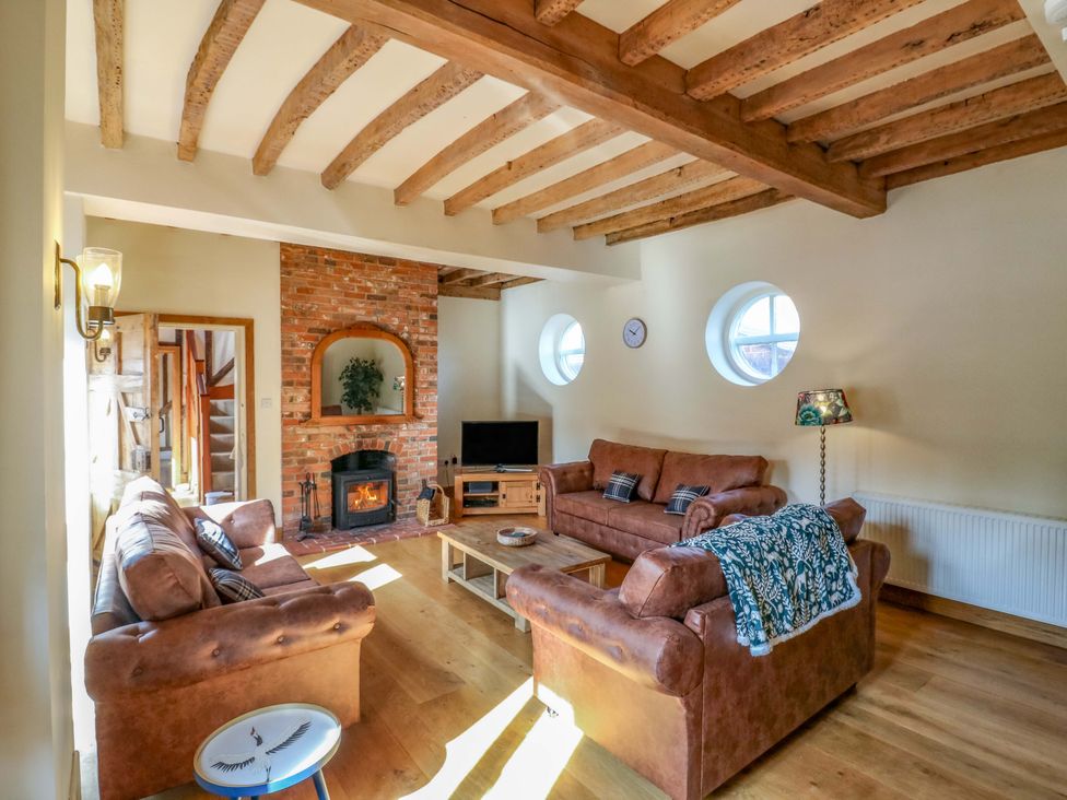 A living room with a sofa and coffee table at Six Apples Wethersfield near Finchingfield