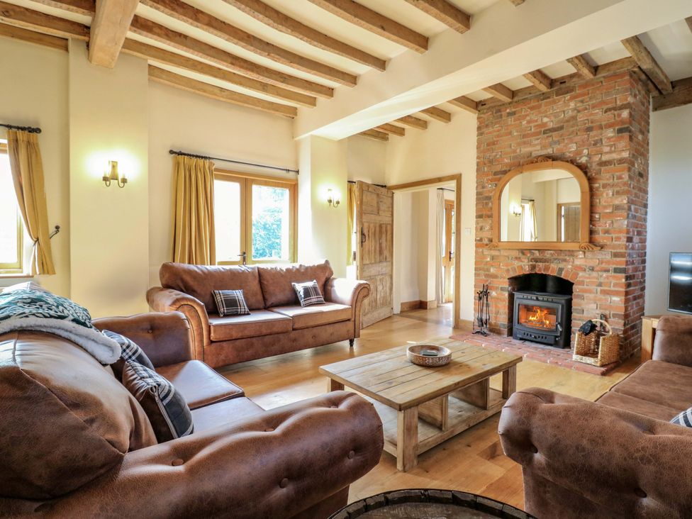 A living room with a coffee table and fireplace at Six Apples in Wethersfield near Finchingfield