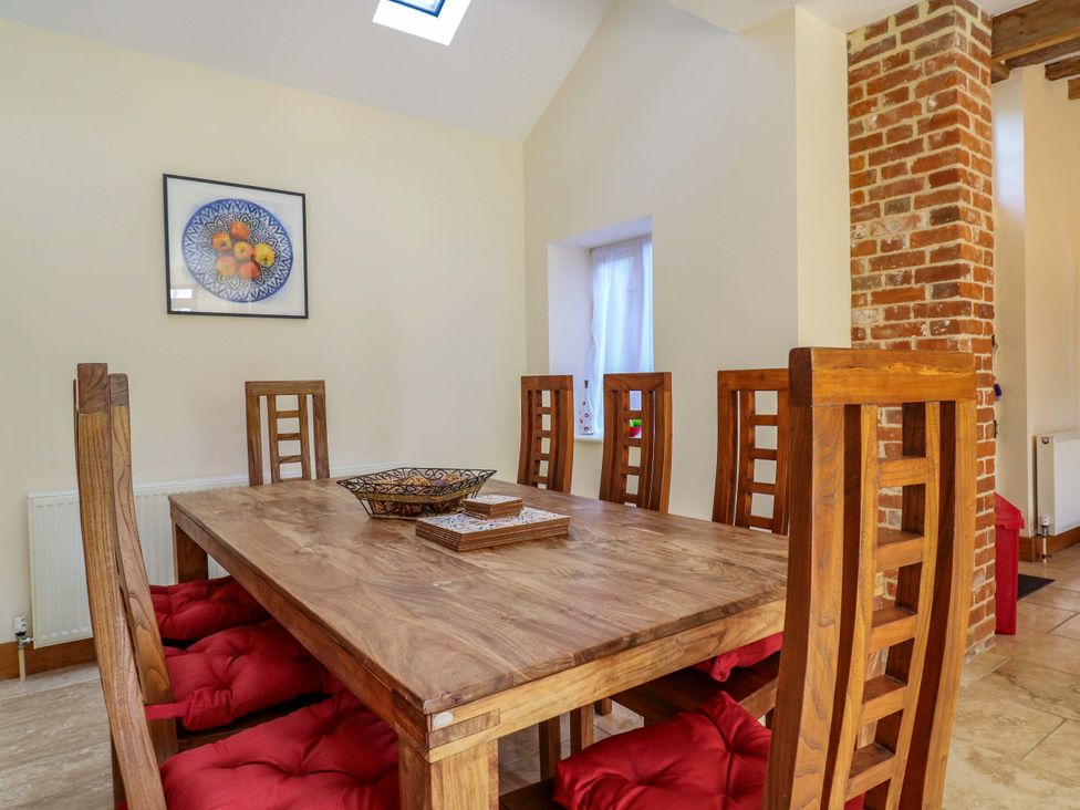 A dining room with a wooden table and chairs at Six Apples in Wethersfield near Finchingfield