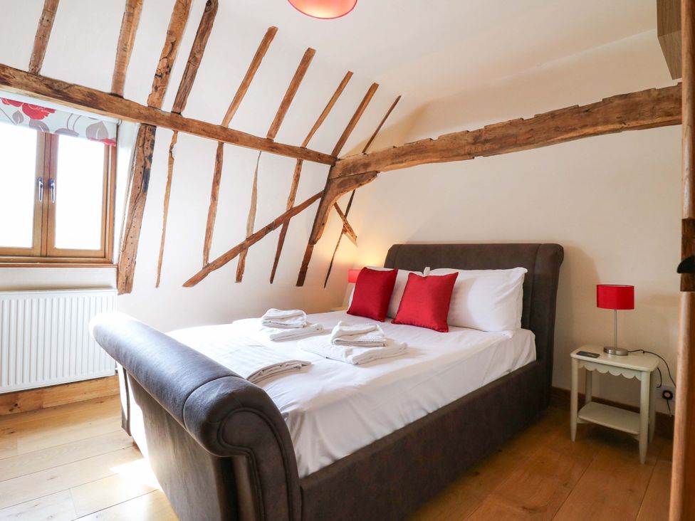 A bedroom with a bed and a window at Six Apples in Wethersfield near Finchingfield