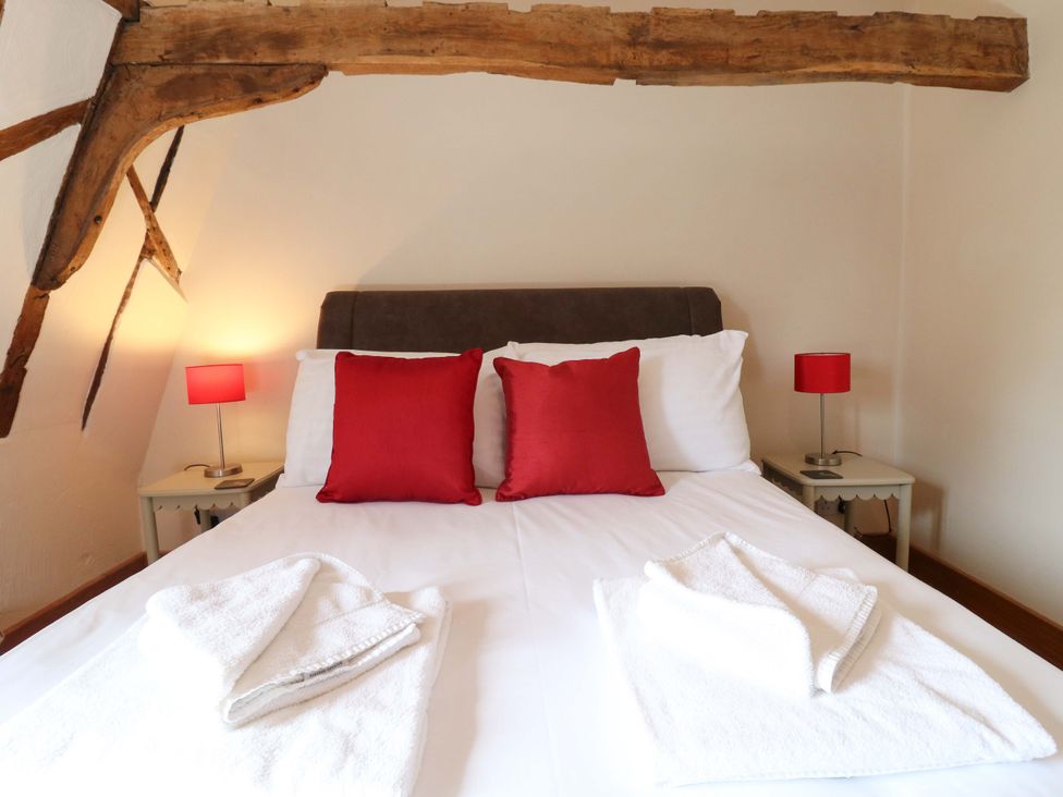 A bedroom with a bed and lamps at Six Apples in Wethersfield near Finchingfield