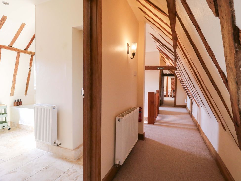 A hallway with wooden beams and a radiator at Six Apples in Wethersfield near Finchingfield