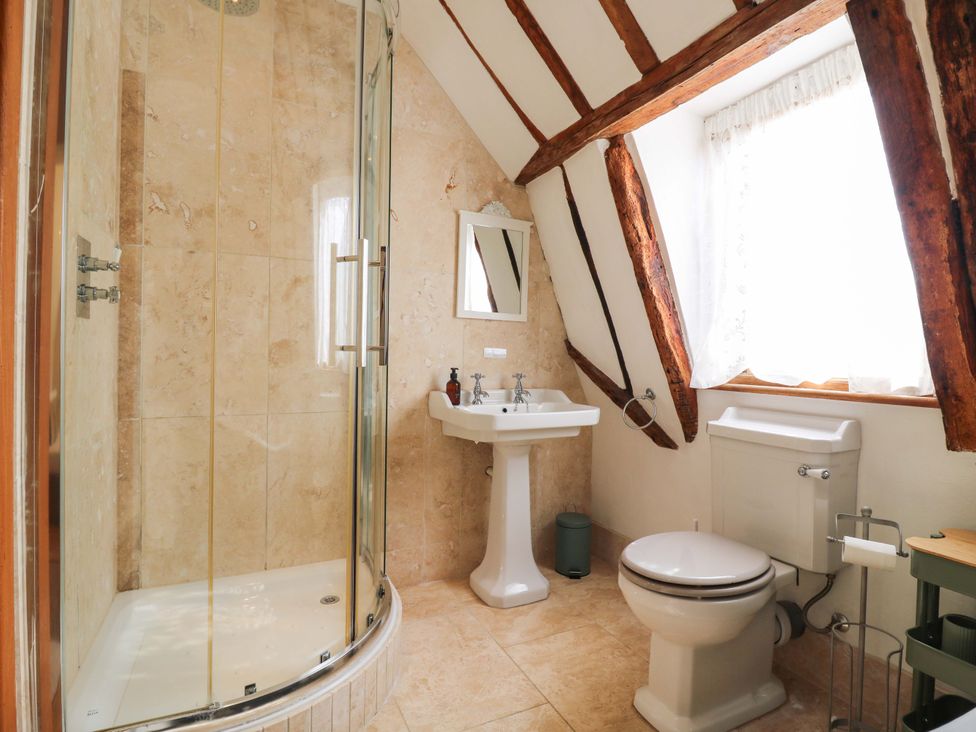 A bathroom with a shower, sink, and toilet at Six Apples in Wethersfield near Finchingfield
