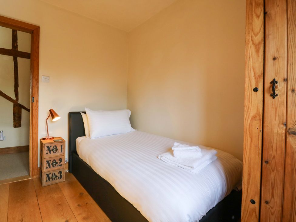 A bedroom with a single bed and a lamp at Six Apples in Wethersfield near Finchingfield