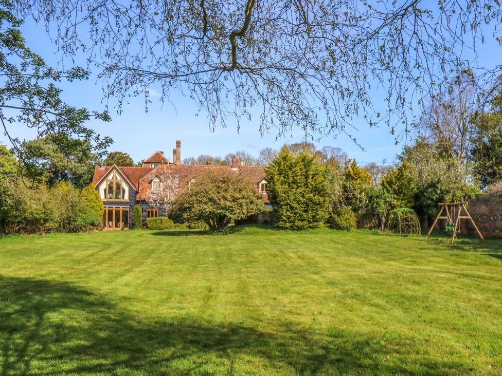 A garden with a house and swing at Six Apples in Wethersfield near Finchingfield