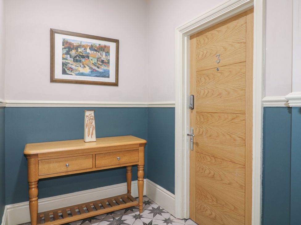 A hallway with a console table and painting at Unit 6 Apt 3 in Sheffield