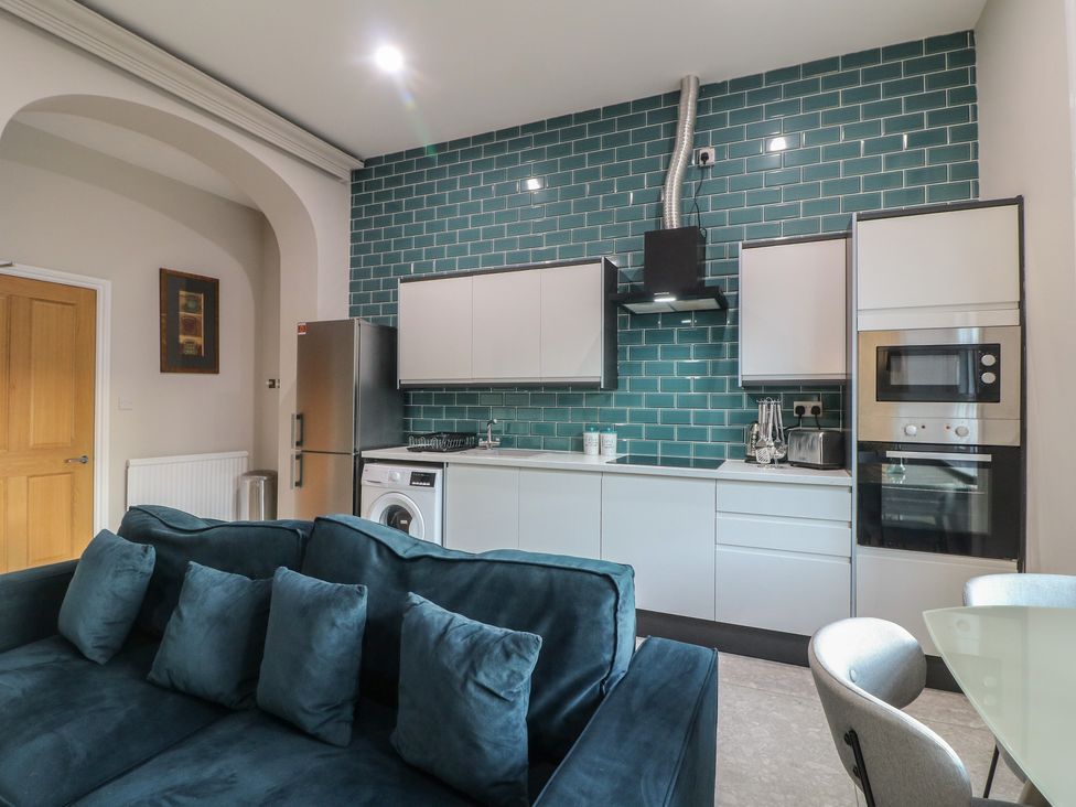 A kitchen with appliances and sofa at Unit 6 Apt 1 Sheffield