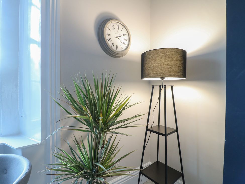 A living room with a clock and plant at Unit 6 Apt 1 in Sheffield