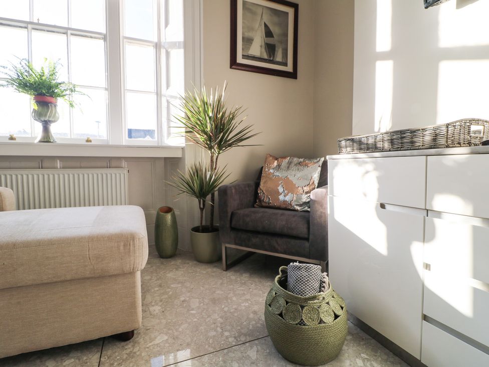 A snug area with armchair and plants at Unit 7 Apt 2 Sheffield