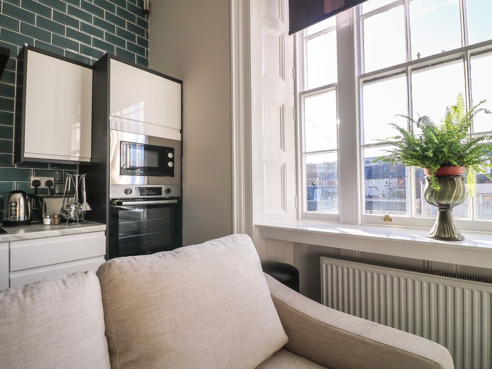 A kitchen with modern appliances and a sofa at Unit 7 Apt 2 Sheffield